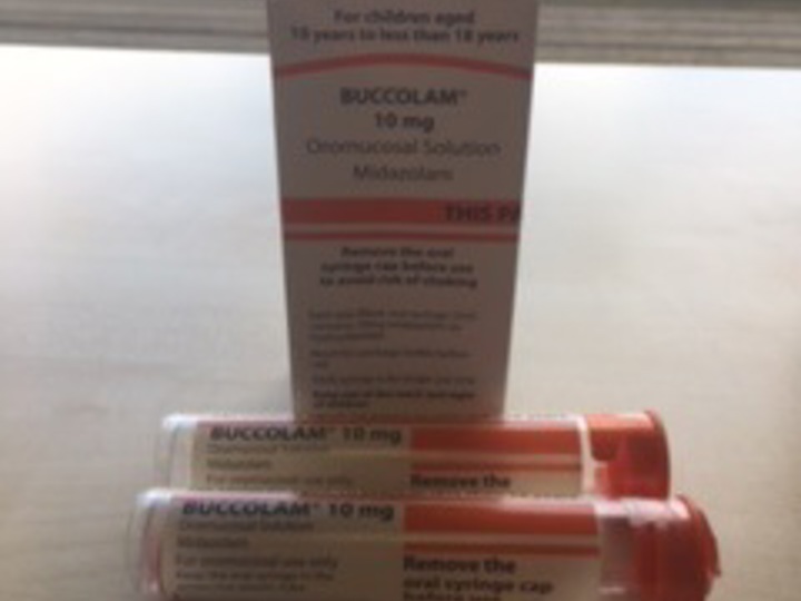 A box of Buccal Midazolam with two syringes placed in front