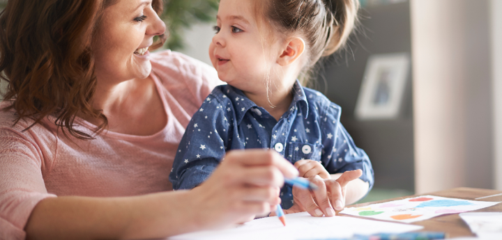 adult and child drawing together