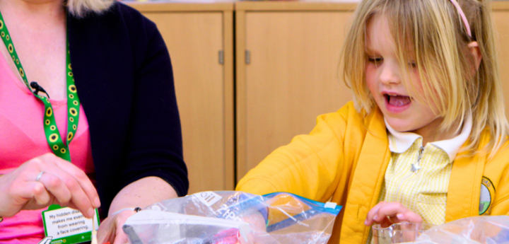 Child Playing With Toys With An Adult In A Clinic