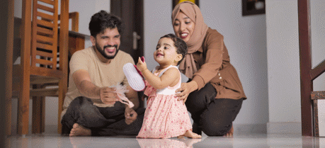 Happy Indian Muslim Family with little Daughter at Home