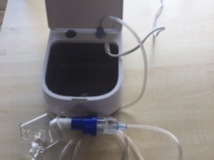 A nebuliser laying open on a table