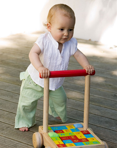 Baby walking with Push And Pull toy with colourful wooden blocks in