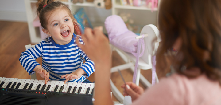 child singing and playing the keyboard