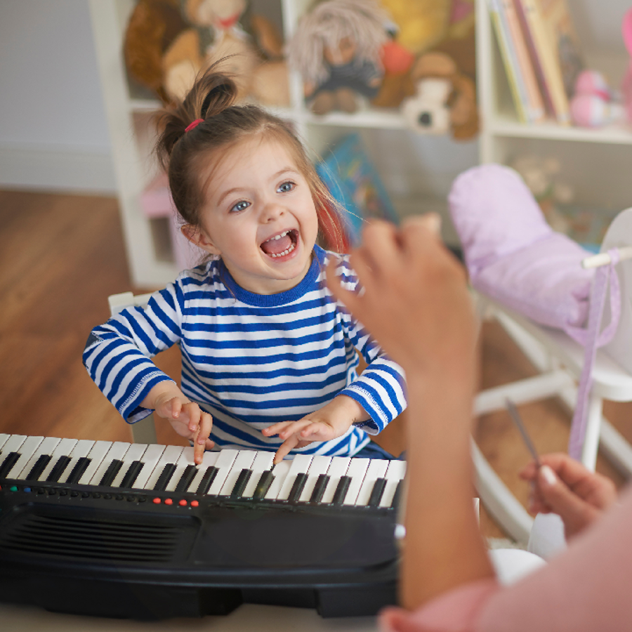 child singing and playing the keyboard