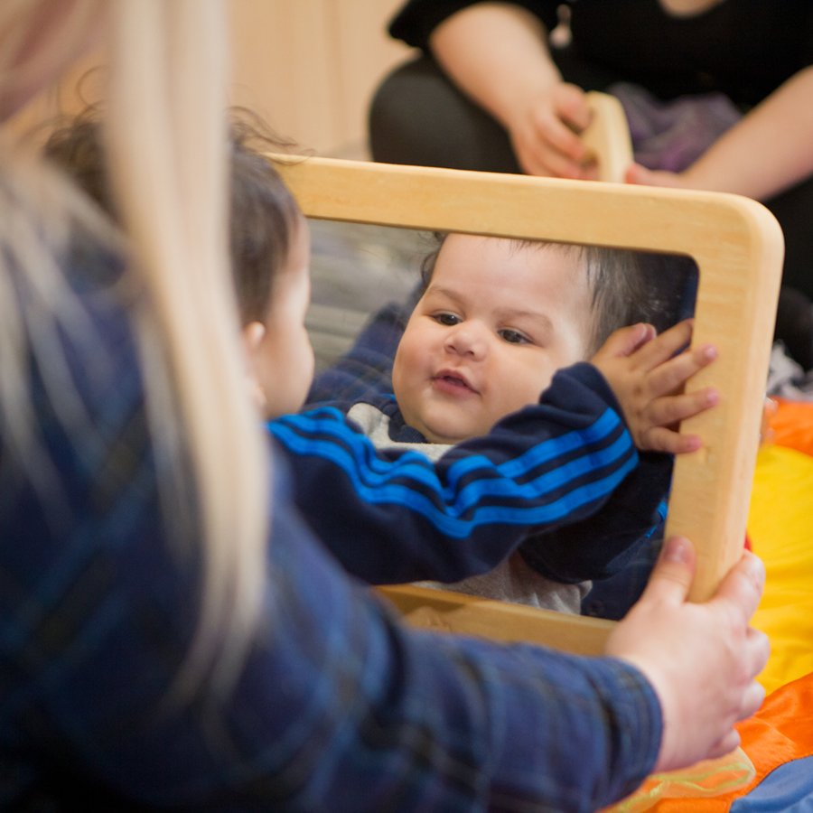 baby playing with mirror