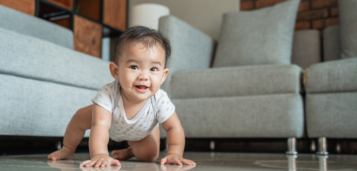 Baby crawling on floor in a living room