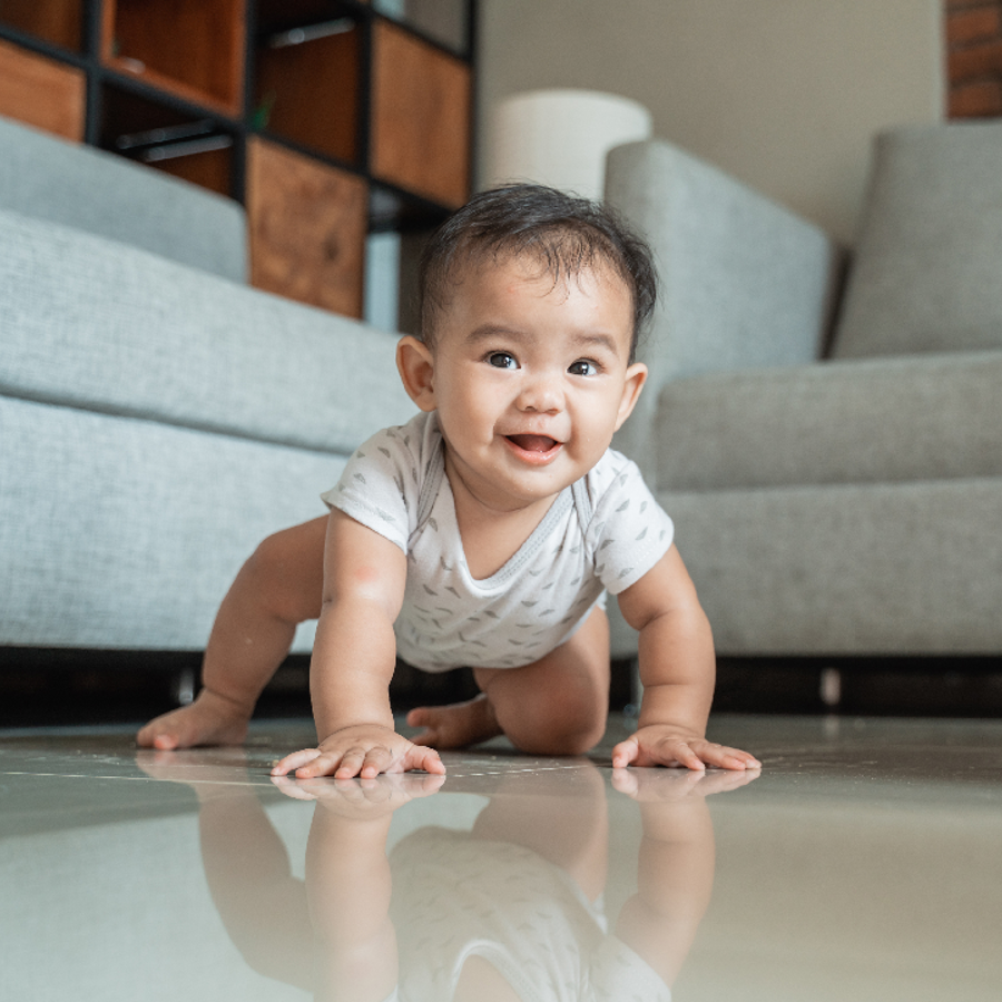 Baby crawling on floor in a living room