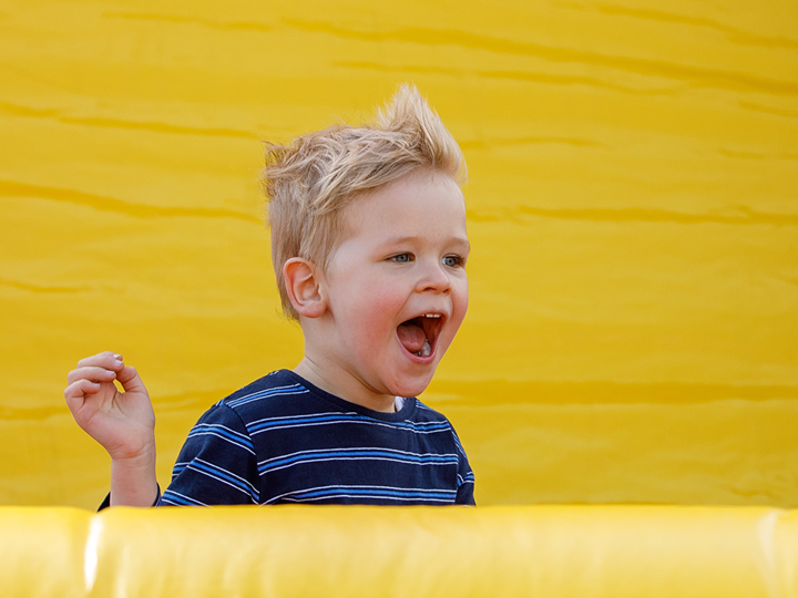 Little boy having fun in inflatable playground