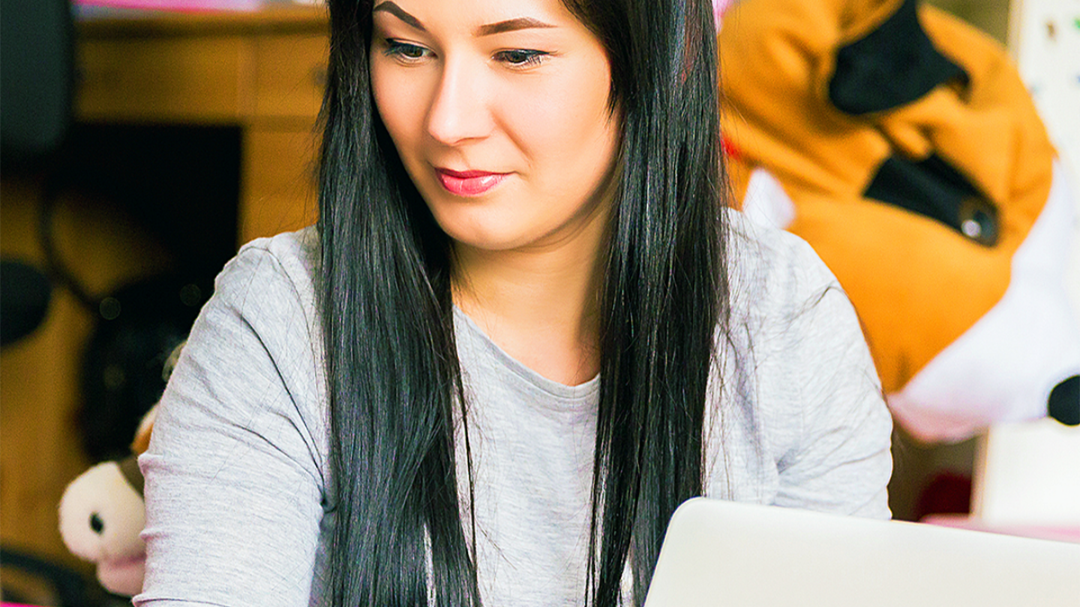 Woman sitting down on a laptop