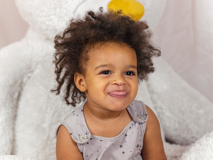 Young child sticking their tongue out with a cheeky smile