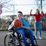 Boy sat in a wheelchair playing basketball 